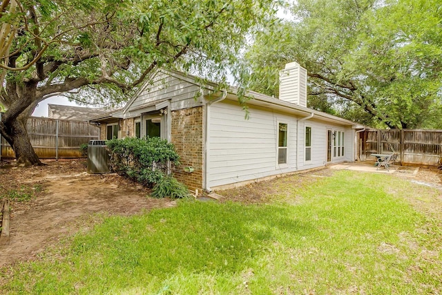 2204 Mediterranean Ave, Arlington, TX 76011 - back of property featuring a chimney, central air condition unit, and brick siding