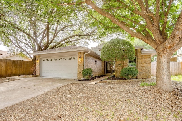 2204 Mediterranean Ave, Arlington, TX 76011 - view of front facade with fence, an attached garage, concrete driveway, and brick siding