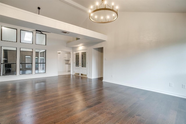 2204 Mediterranean Ave, Arlington, TX 76011 - unfurnished living room featuring a chandelier, dark wood-type flooring, a high ceiling, and baseboards