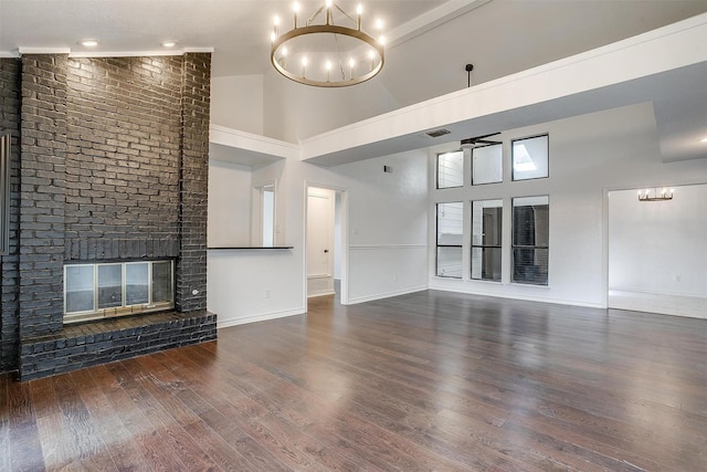 2204 Mediterranean Ave, Arlington, TX 76011 - unfurnished living room featuring a chandelier, high vaulted ceiling, wood finished floors, a brick fireplace, and baseboards
