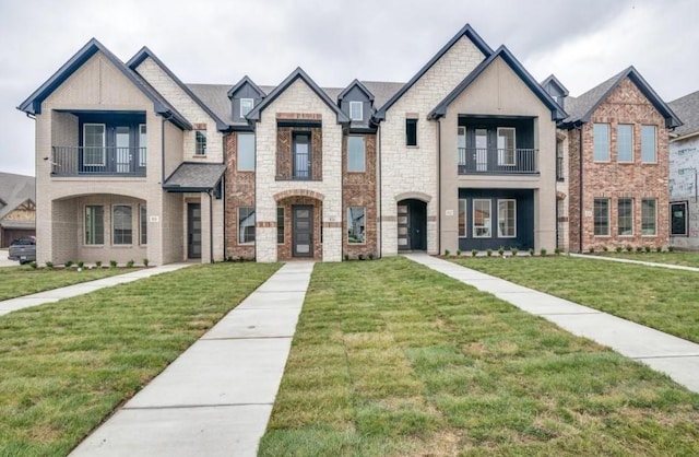 822 Eaglescliffe Lndg, Wylie, TX 75098 - view of front of house featuring a balcony, a front yard, and brick siding