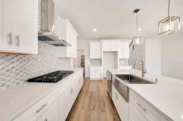 220 E Park St, Little Elm, TX 75068 - kitchen featuring wall chimney range hood, gas stovetop, a sink, light wood-style floors, and stainless steel dishwasher