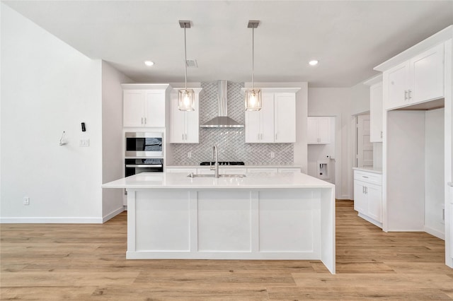 220 E Park St, Little Elm, TX 75068 - kitchen featuring wall chimney exhaust hood, tasteful backsplash, white cabinets, appliances with stainless steel finishes, and light countertops