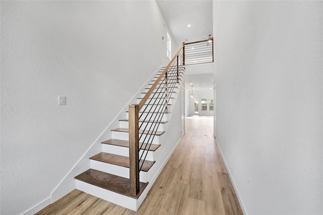 220 E Park St, Little Elm, TX 75068 - staircase featuring baseboards, wood finished floors, and a towering ceiling