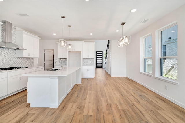 220 E Park St, Little Elm, TX 75068 - kitchen featuring wall chimney range hood, black stovetop, tasteful backsplash, light wood-type flooring, and recessed lighting