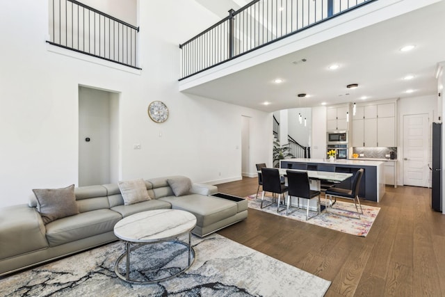3747 Connie Ln, Frisco, TX 75033 - living area featuring wood finished floors, stairway, a high ceiling, baseboards, and recessed lighting