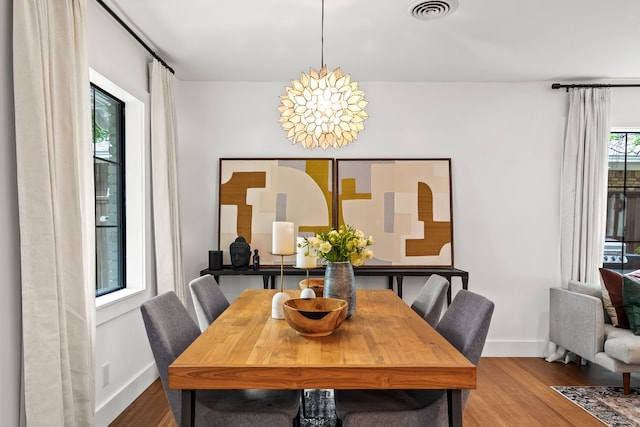 9115 Longmont Dr, Dallas, TX 75238 - dining area with wood finished floors and baseboards