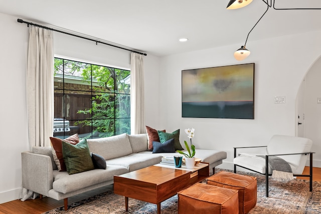 9115 Longmont Dr, Dallas, TX 75238 - living area featuring arched walkways, wood finished floors, baseboards, and recessed lighting
