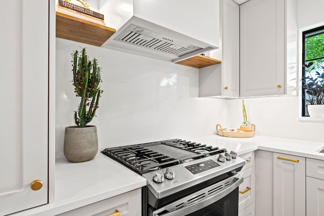 9115 Longmont Dr, Dallas, TX 75238 - kitchen with gas range, custom exhaust hood, white cabinets, decorative backsplash, and light stone counters