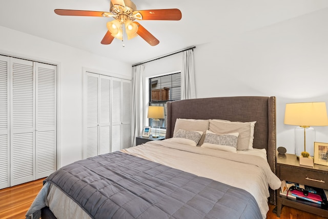 9115 Longmont Dr, Dallas, TX 75238 - bedroom with two closets, wood finished floors, and a ceiling fan