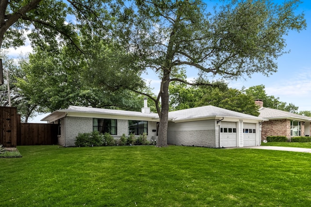 9115 Longmont Dr, Dallas, TX 75238 - mid-century home featuring an attached garage, a chimney, brick siding, and driveway