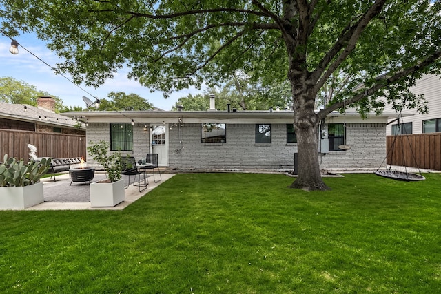 9115 Longmont Dr, Dallas, TX 75238 - rear view of house featuring a fire pit, a patio, and brick siding