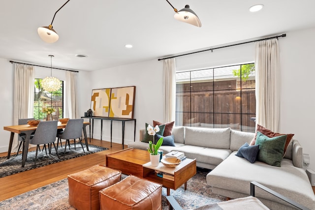 9115 Longmont Dr, Dallas, TX 75238 - living room featuring plenty of natural light, wood finished floors, recessed lighting, and baseboards