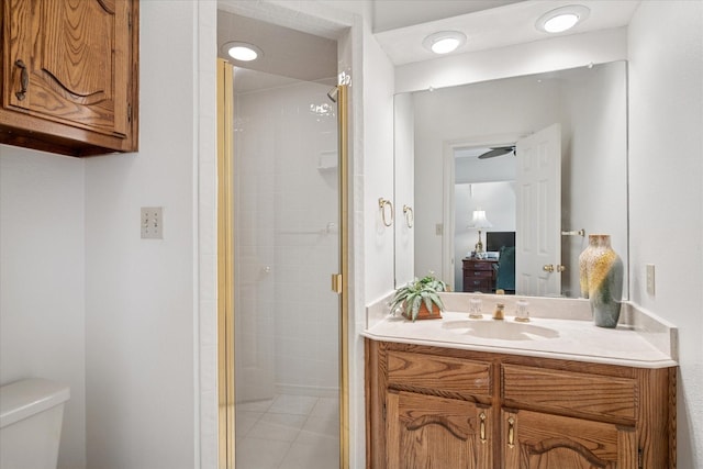 3517 Louis Dr, Plano, TX 75023 - bathroom featuring a stall shower, toilet, vanity, and a ceiling fan