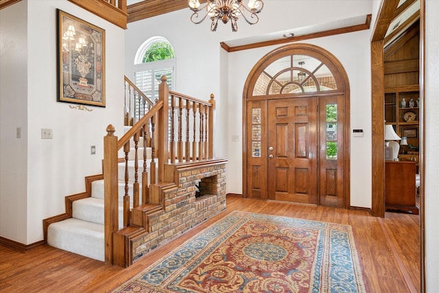 3517 Louis Dr, Plano, TX 75023 - foyer with a chandelier, plenty of natural light, wood finished floors, stairs, and crown molding