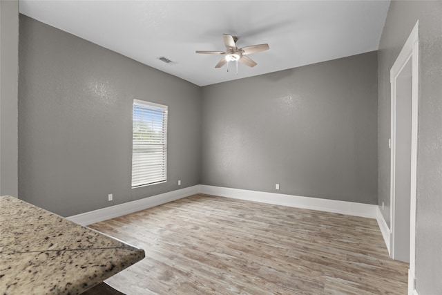 2721 Ave G, Fort Worth, TX 76105 - unfurnished bedroom featuring light wood-style flooring, baseboards, and ceiling fan