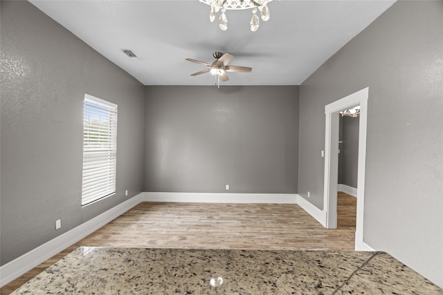 2721 Ave G, Fort Worth, TX 76105 - empty room with a chandelier, wood finished floors, baseboards, and ceiling fan