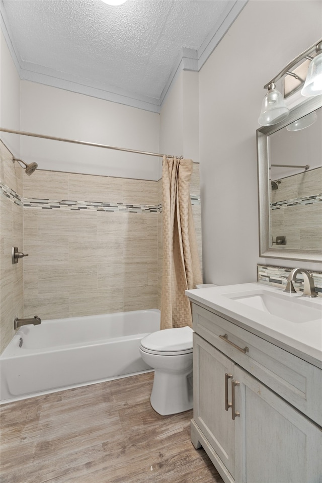 2721 Ave G, Fort Worth, TX 76105 - full bathroom featuring toilet, shower / tub combo, a textured ceiling, vanity, and wood finished floors