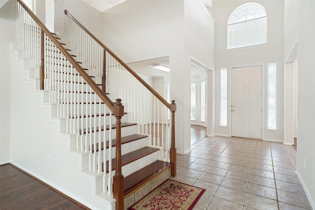 7104 Chandler Dr, Plano, TX 75024 - foyer with stairway, baseboards, a towering ceiling, and tile patterned flooring