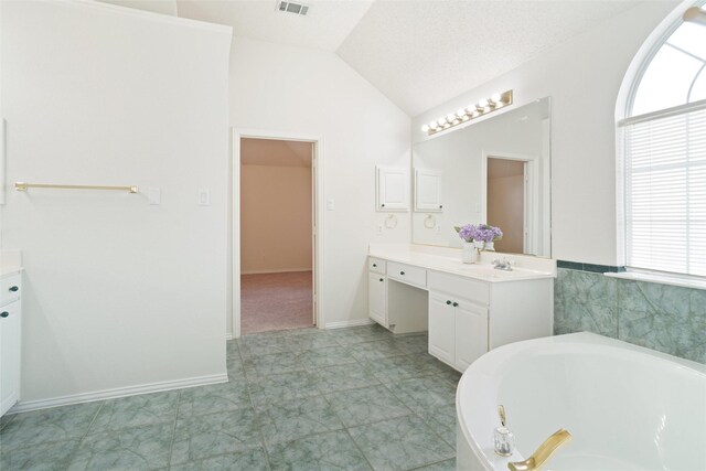 7104 Chandler Dr, Plano, TX 75024 - full bath featuring lofted ceiling, a bath, and vanity