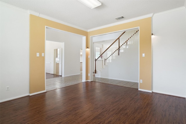 7104 Chandler Dr, Plano, TX 75024 - empty room with wood finished floors, stairway, crown molding, baseboards, and a textured ceiling