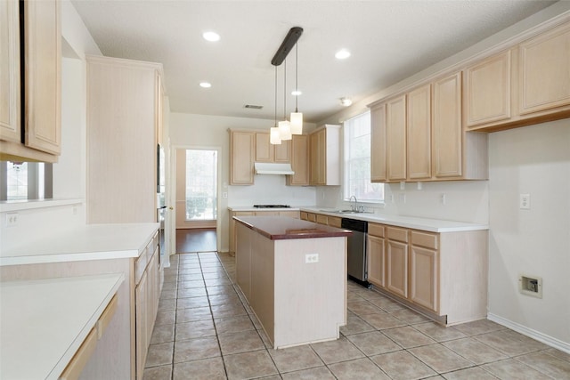 7104 Chandler Dr, Plano, TX 75024 - kitchen featuring under cabinet range hood, light brown cabinets, stainless steel dishwasher, a sink, and gas stovetop