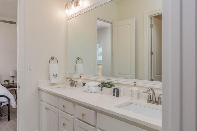 3316 Acorn Hill Trl, Weatherford, TX 76087 - bathroom with double vanity, ensuite bath, and wood finished floors