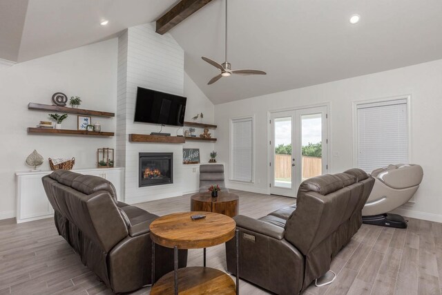3316 Acorn Hill Trl, Weatherford, TX 76087 - living area with beamed ceiling, light wood finished floors, baseboards, a ceiling fan, and a large fireplace