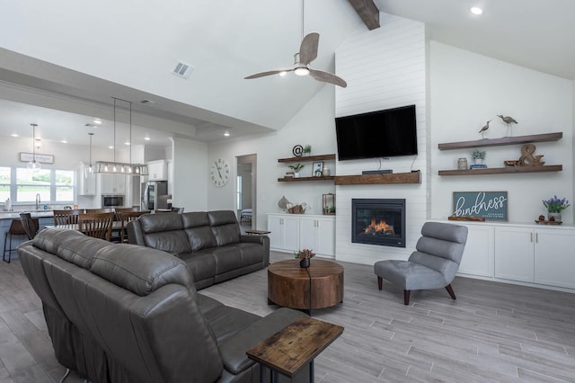 3316 Acorn Hill Trl, Weatherford, TX 76087 - living area with light wood finished floors, beam ceiling, ceiling fan, a large fireplace, and recessed lighting