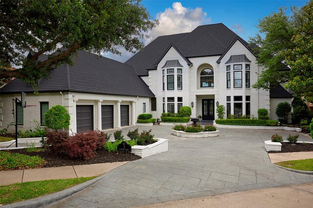 3 Savannah Ridge Dr, Frisco, TX 75034 - french provincial home with a garage, french doors, driveway, and brick siding