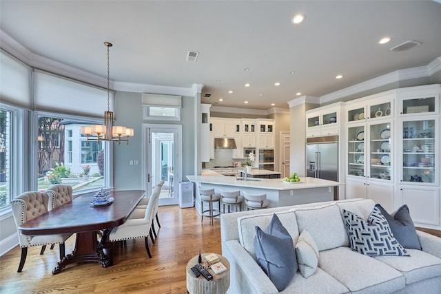 3 Savannah Ridge Dr, Frisco, TX 75034 - living room with a chandelier, ornamental molding, healthy amount of natural light, light wood-style flooring, and recessed lighting