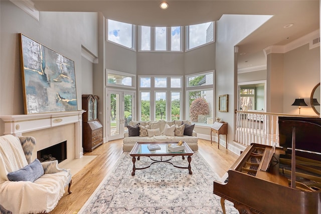3 Savannah Ridge Dr, Frisco, TX 75034 - living area featuring wood finished floors, crown molding, a high end fireplace, a high ceiling, and recessed lighting