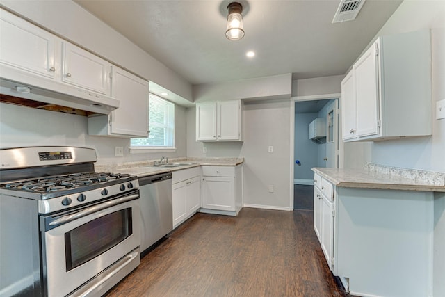 729 Grubb Cir, Mesquite, TX 75149 - kitchen featuring appliances with stainless steel finishes, under cabinet range hood, light countertops, a sink, and dark wood-style floors