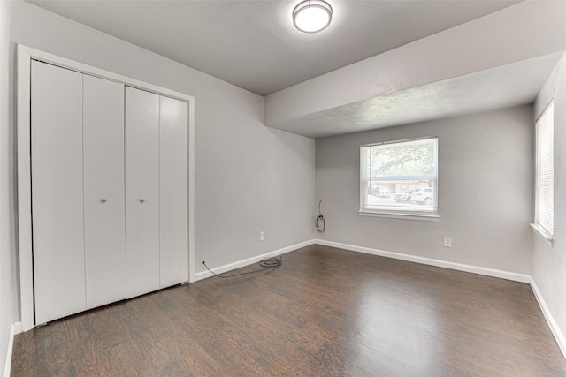 729 Grubb Cir, Mesquite, TX 75149 - unfurnished bedroom with wood finished floors, baseboards, and a closet