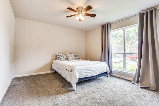 605 Sevilla Dr, Garland, TX 75043 - bedroom with carpet floors, baseboards, and a ceiling fan