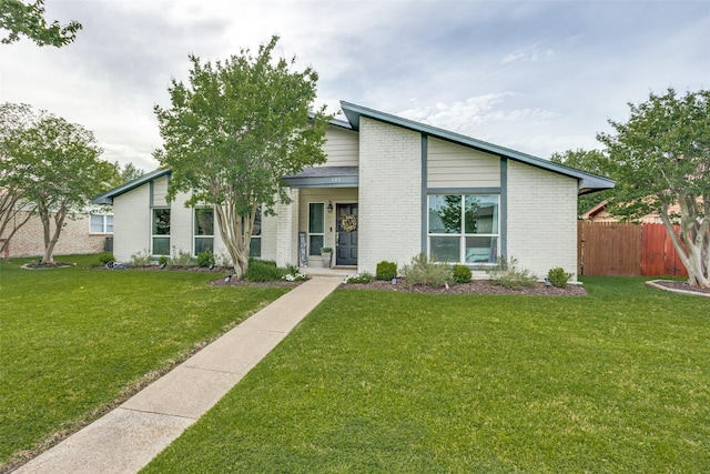 605 Sevilla Dr, Garland, TX 75043 - mid-century modern home featuring brick siding and a porch