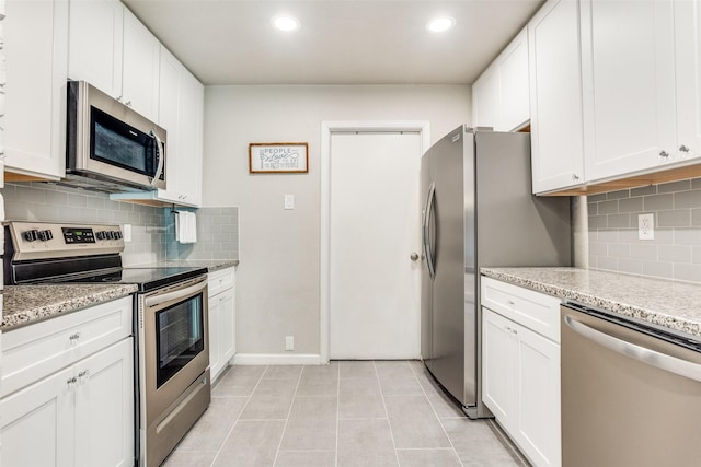 605 Sevilla Dr, Garland, TX 75043 - kitchen with appliances with stainless steel finishes, white cabinets, backsplash, light stone countertops, and recessed lighting