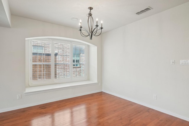 2545 Sedalia Ct, Frisco, TX 75034 - unfurnished room featuring a chandelier, wood finished floors, arched walkways, and baseboards