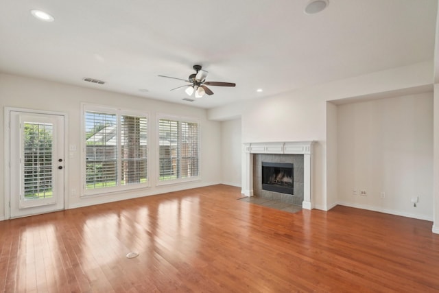2545 Sedalia Ct, Frisco, TX 75034 - unfurnished living room with plenty of natural light, ceiling fan, wood finished floors, a tile fireplace, and recessed lighting