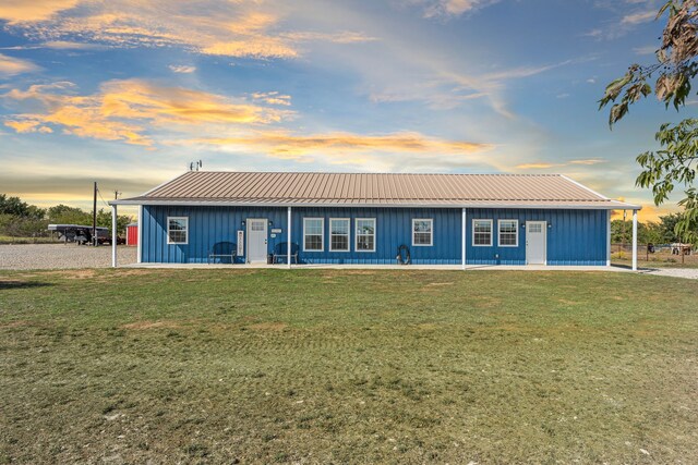 179 Johnston Dr, Decatur, TX 76234 - view of front of home with board and batten siding, metal roof, and a front lawn
