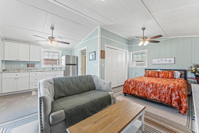 179 Johnston Dr, Decatur, TX 76234 - bedroom featuring freestanding refrigerator, concrete flooring, lofted ceiling, cooling unit, and a closet