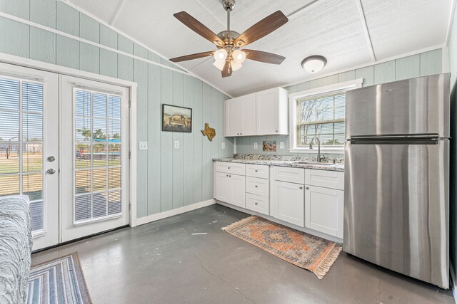 179 Johnston Dr, Decatur, TX 76234 - kitchen featuring freestanding refrigerator, french doors, vaulted ceiling, a sink, and concrete floors