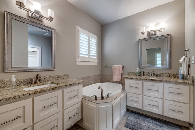 410 Phillips Ct, Mansfield, TX 76063 - bathroom featuring two vanities and a garden tub
