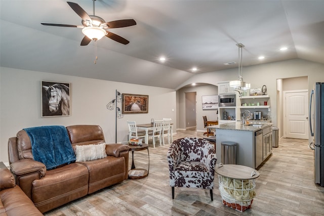 410 Phillips Ct, Mansfield, TX 76063 - living area with lofted ceiling, a ceiling fan, arched walkways, light wood finished floors, and recessed lighting