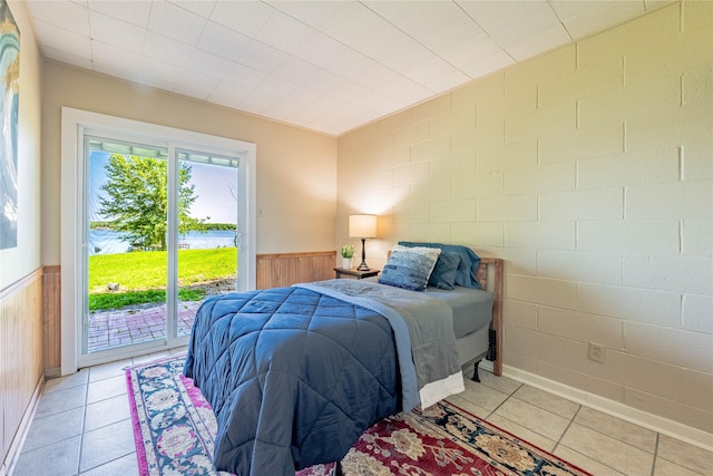 152 Pin Oak, Mabank, TX 75156 - bedroom with access to outside, wainscoting, light tile patterned floors, and wooden walls