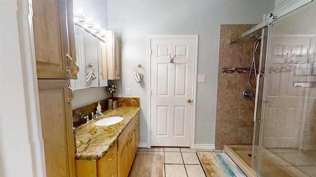 1407 Lady Amber Ln, Granbury, TX 76049 - bathroom featuring a shower stall, tile patterned flooring, vanity, and baseboards
