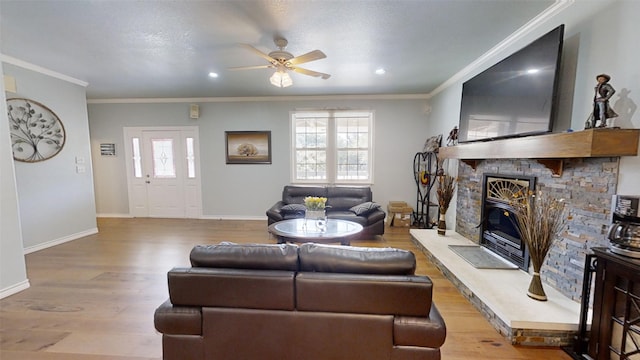 1407 Lady Amber Ln, Granbury, TX 76049 - living area featuring a ceiling fan, crown molding, wood finished floors, a fireplace, and baseboards