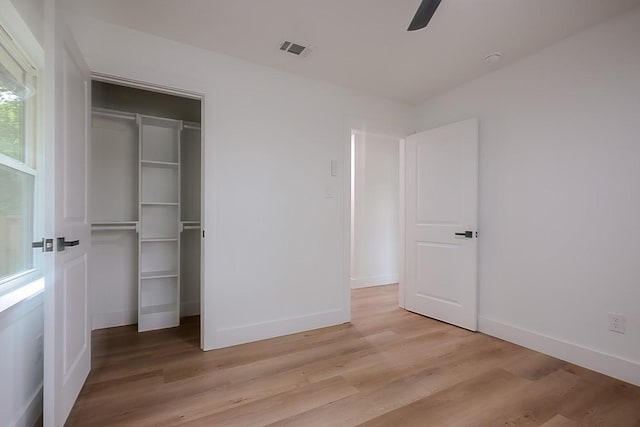 701 N Carrier Pkwy, Grand Prairie, TX 75050 - unfurnished bedroom with a closet, light wood-style floors, baseboards, and ceiling fan
