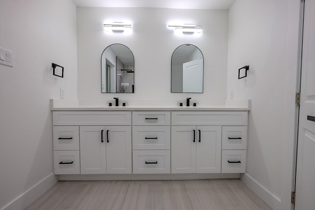 701 N Carrier Pkwy, Grand Prairie, TX 75050 - bathroom featuring baseboards and double vanity