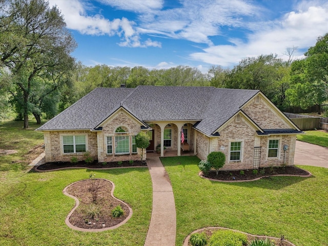 104 Lost Oaks Dr, Waco, TX 76705 - view of front of property featuring a shingled roof, a front lawn, and brick siding